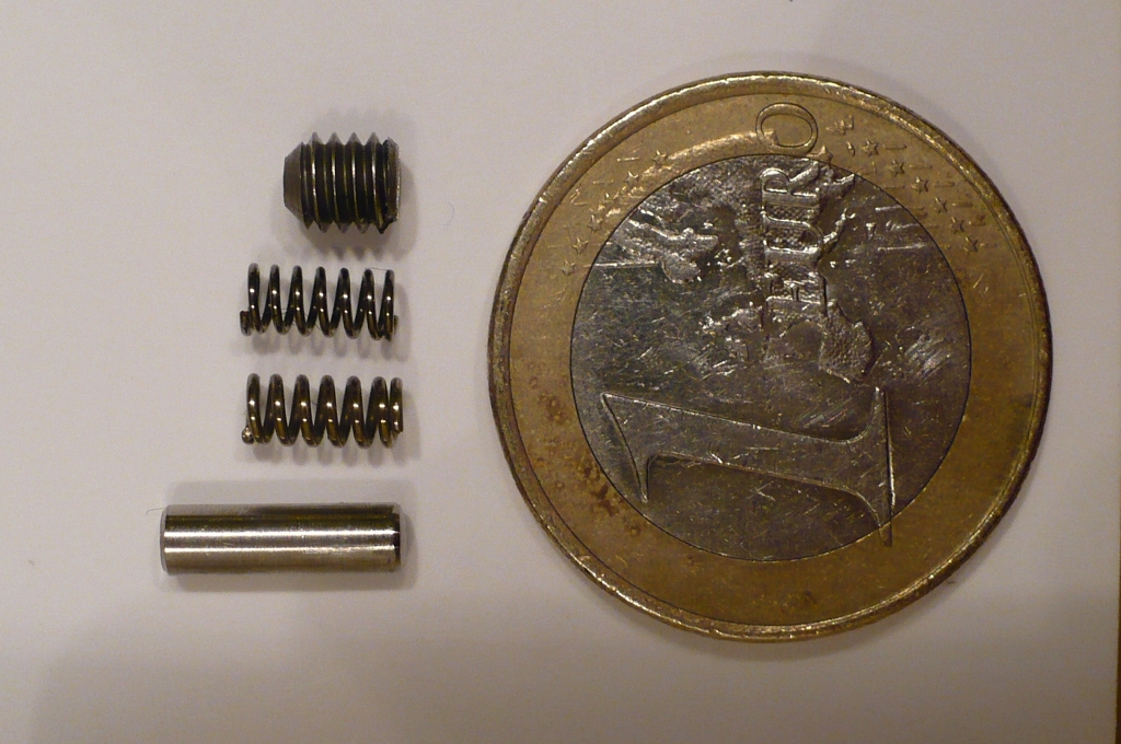 Top to bottom:  Threaded plug, my spring, official spring, official pin.