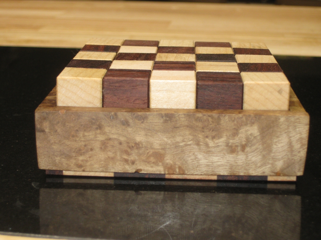 A final view from the side, showing the effect of the checkered base.  The myrtle burl box almost looks like its floating.